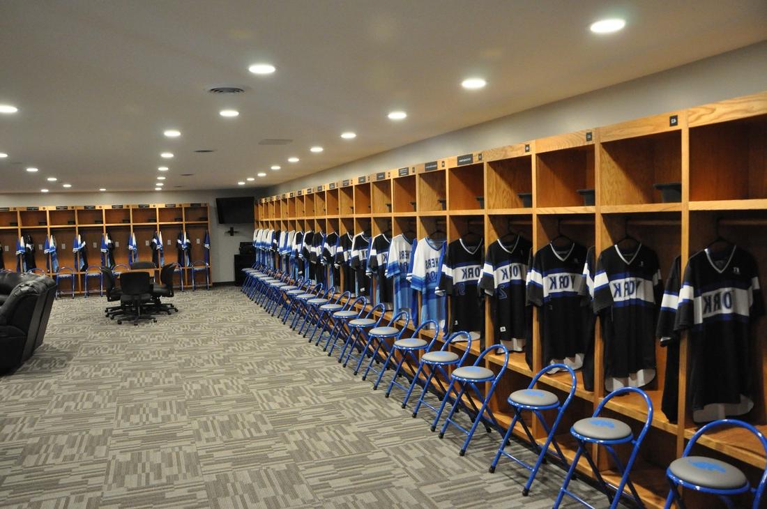 lockers with baseball jerseys hanging in them